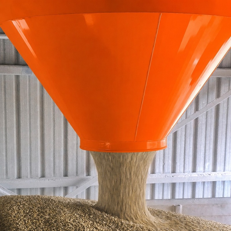 Schüttgut fällt durch den orangen Dust Stop Trichter